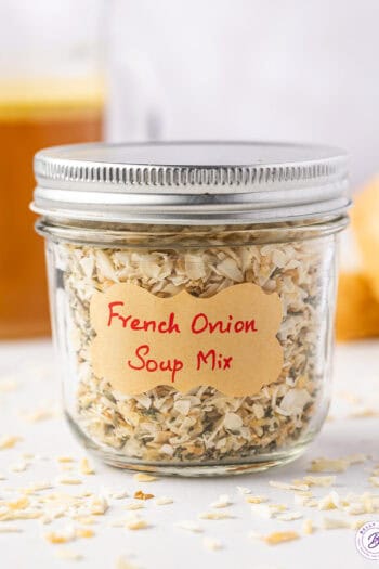 Side view of dry french onion soup mix in a glass mason jar.