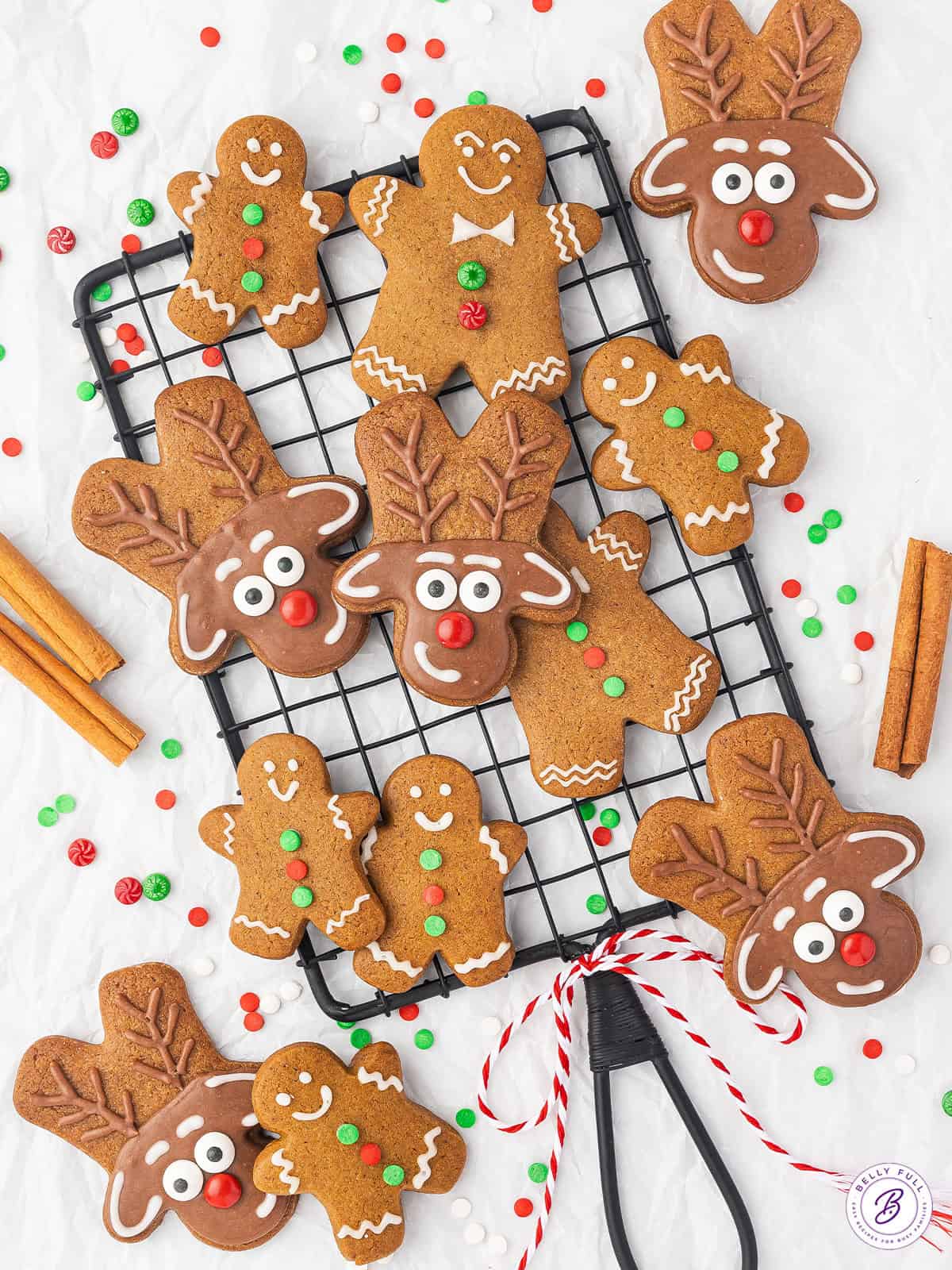 Gingerbread men cookies and reindeer cookies on a cooling rack