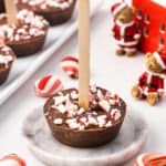 A hot chocolate on a stick on a plate