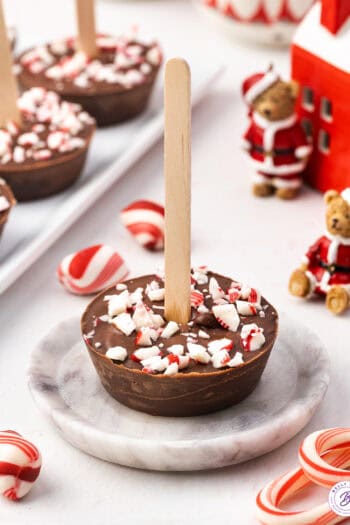 A hot chocolate on a stick on a plate