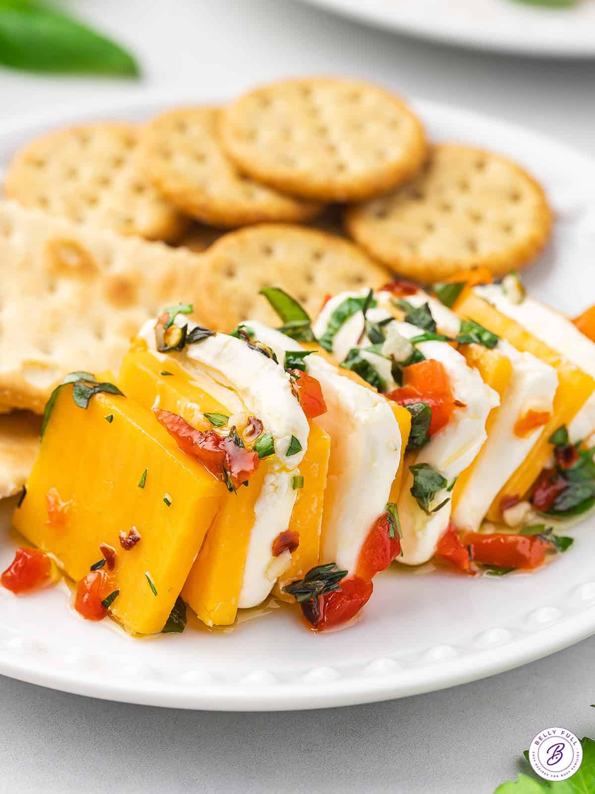 Marinated cheese on a plate with crackers