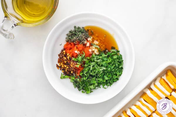 Oil, vinegar, and herbs in a bowl