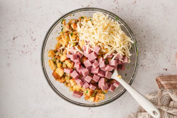 Cubes of bread, cheese, and ham in a bowl.