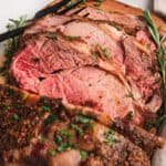 Overhead view of a roasted prime rib roast sliced in half.