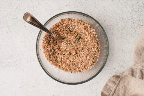 Prime rib rub in a bowl with a spoon.