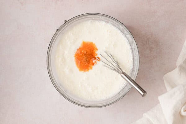 Whisking sour cream and vanilla into the half-n-half jello mixture