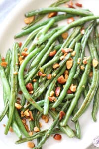 overhead Roasted Green Beans with chopped almonds on serving platter