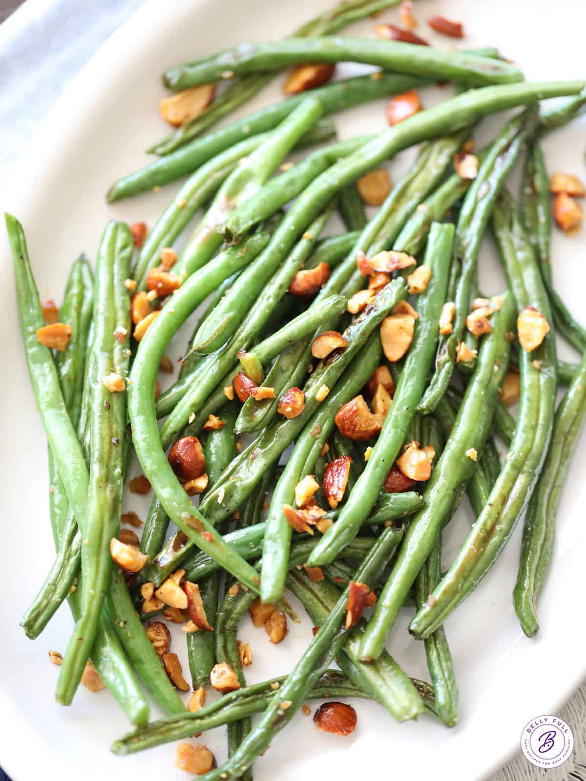 overhead Roasted Green Beans with chopped almonds on serving platter