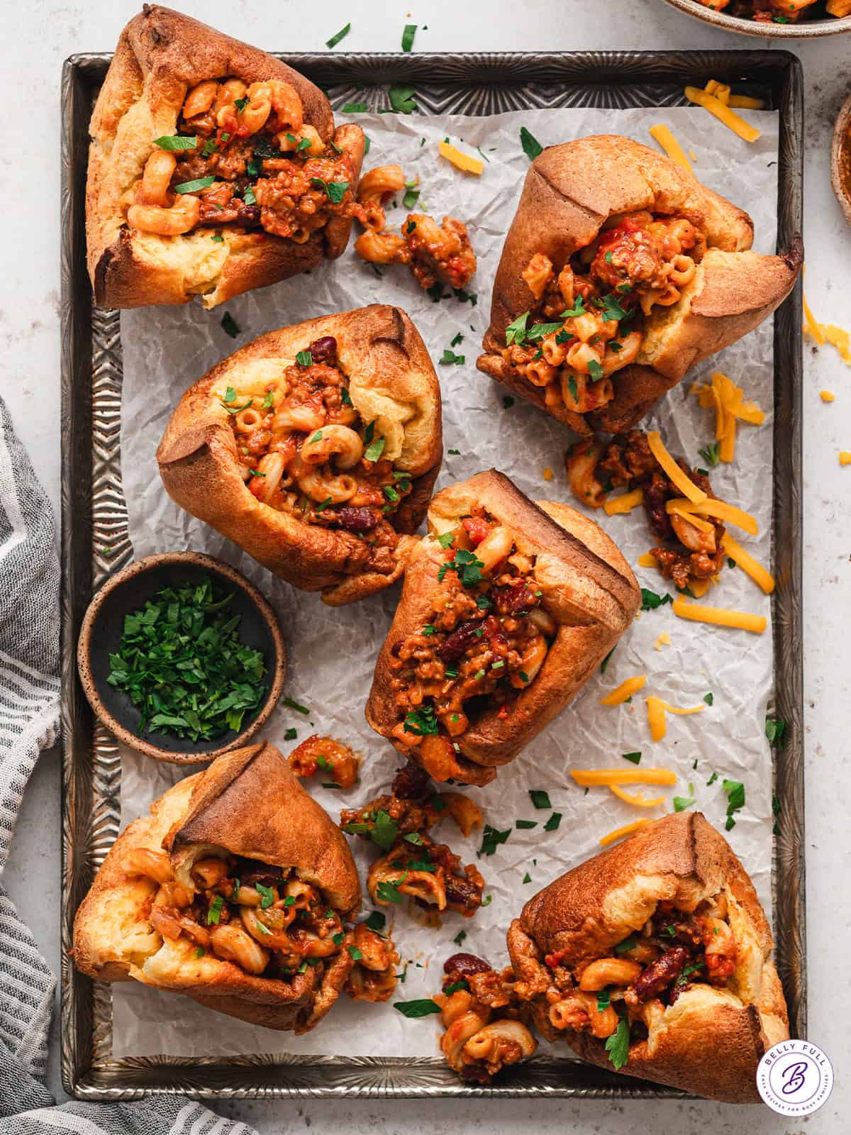 Overhead view of chili mac popovers on a baking sheet