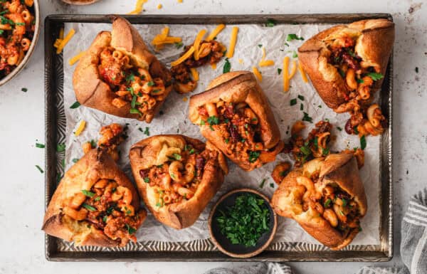 Overhead view of a baking sheet of chili mac stuffed popovers