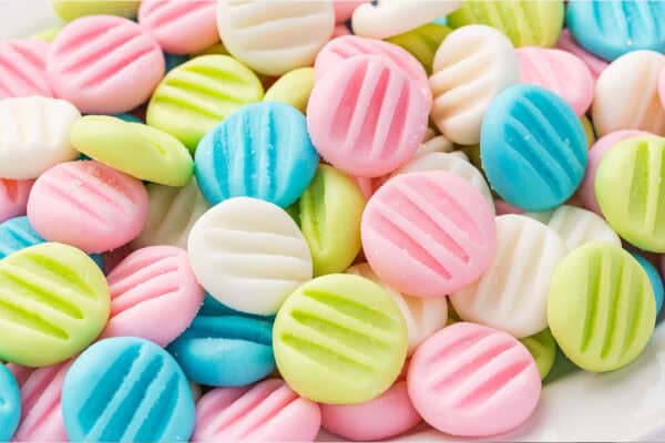 close up pink, blue, green, and white cream cheese button mints