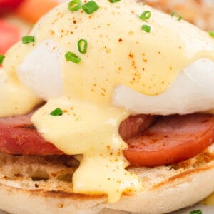 Eggs benedict topped with hollandaise sauce