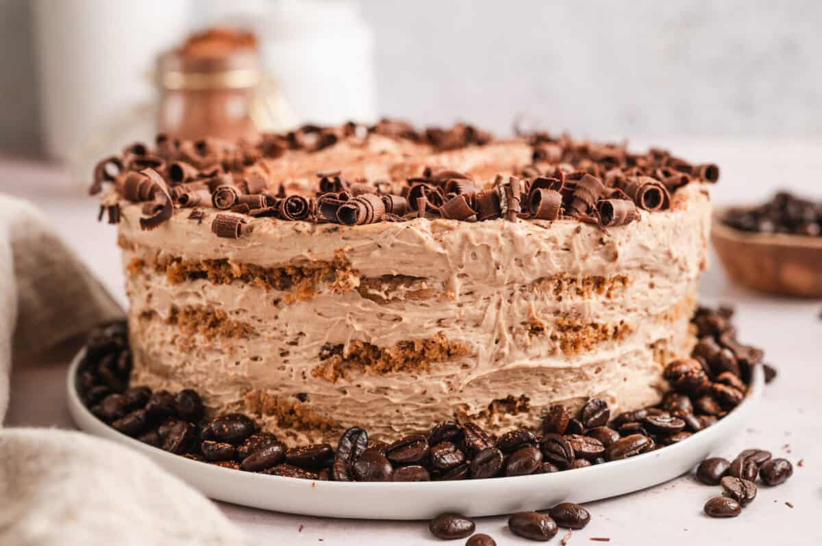 side view of uncut mocha icebox cake with chocolate curls