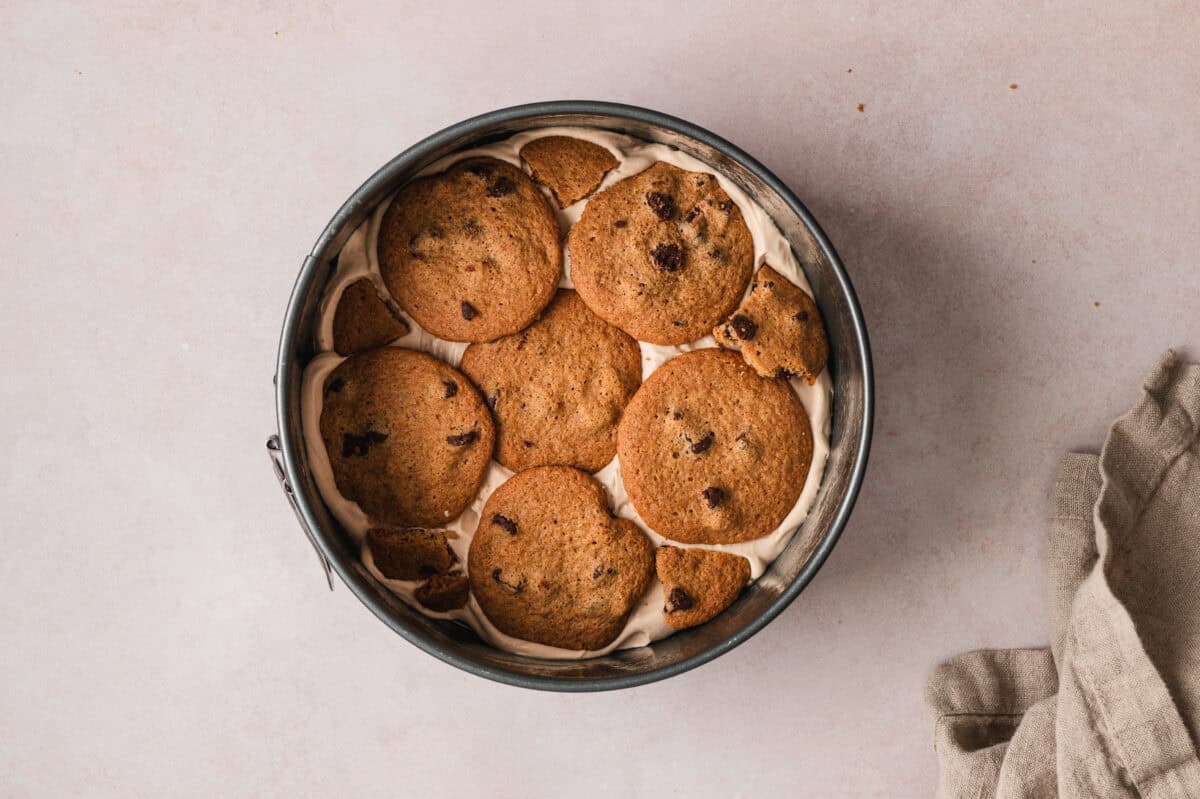 layer of chocolate chip cookies on top of whipped cream layer in springform pan