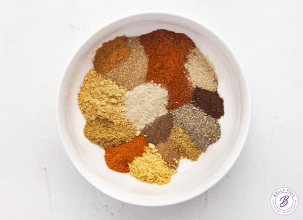 A bowl of various spices in a white bowl