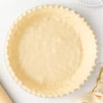 overhead unbaked pie crust with crimped edges