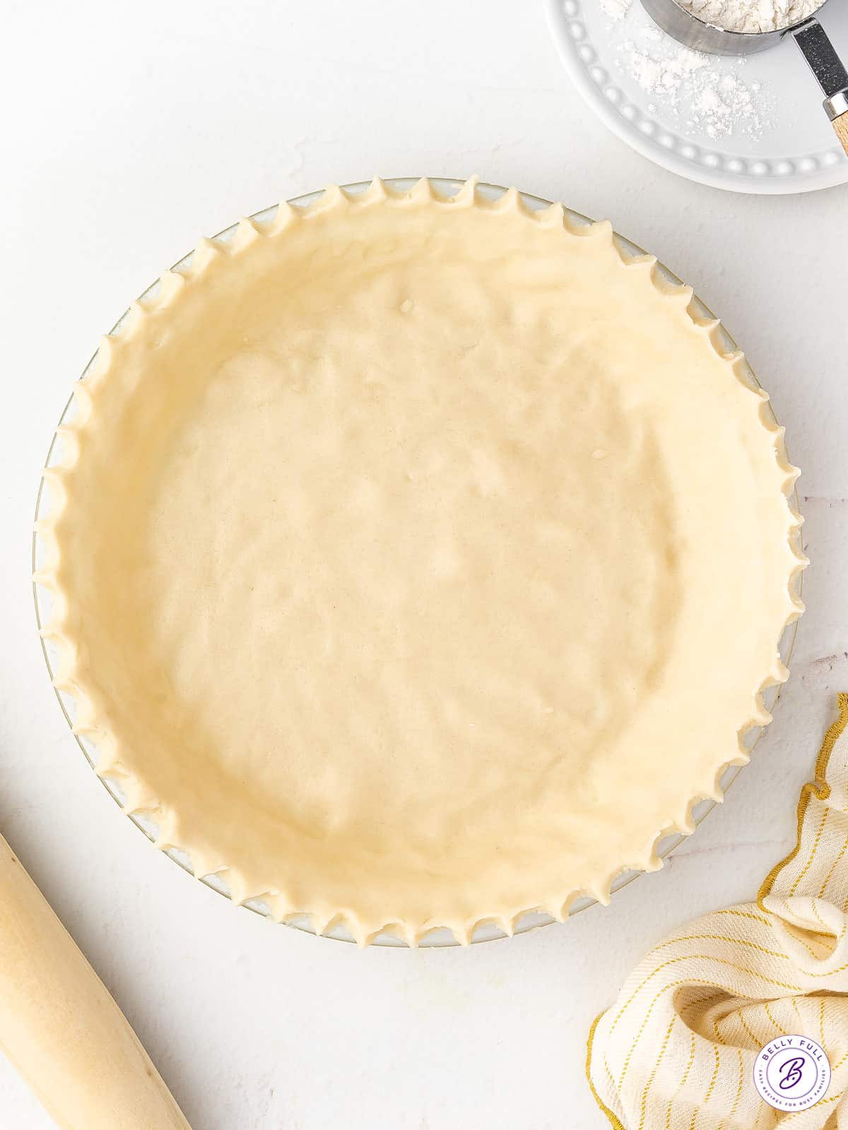 overhead unbaked pie crust with crimped edges