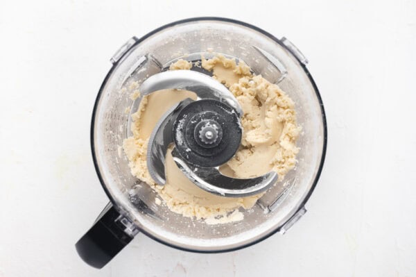 flour and vegetables shortening blended together in bowl of food processor