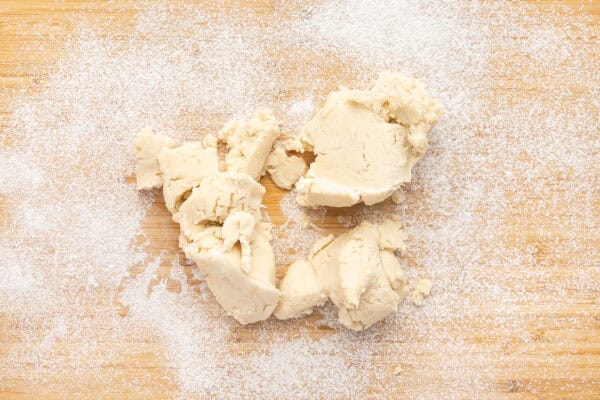 large pieces of pie crust dough on floured work surface