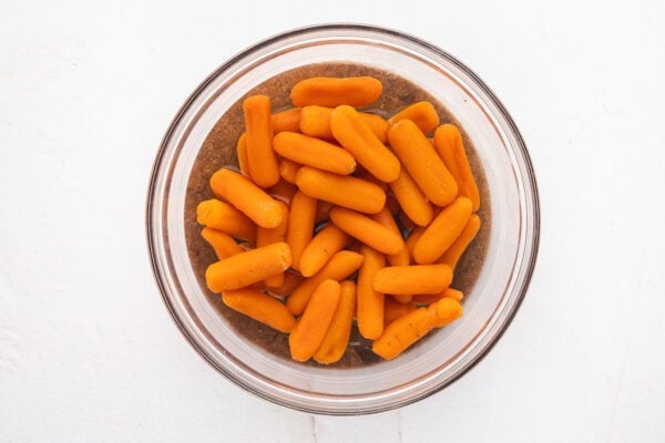 Baby carrots in a bowl of water