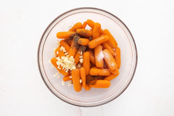 Seasonings in a bowl with baby carrots