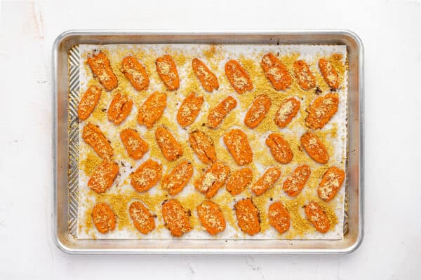 Baked parmesan smashed carrots on a baking sheet