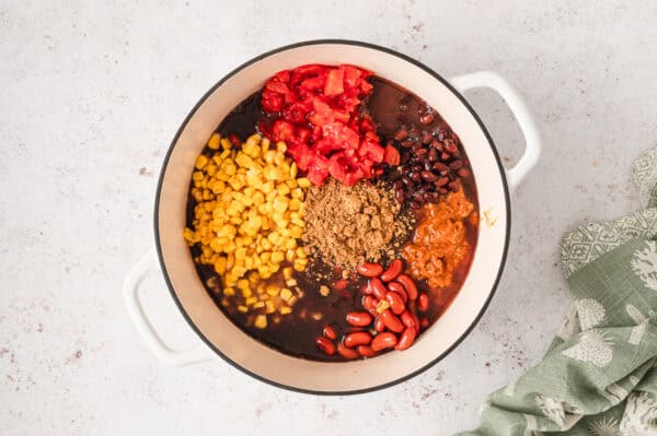 Beans, Rotel, corn, and seasonings in a pot.