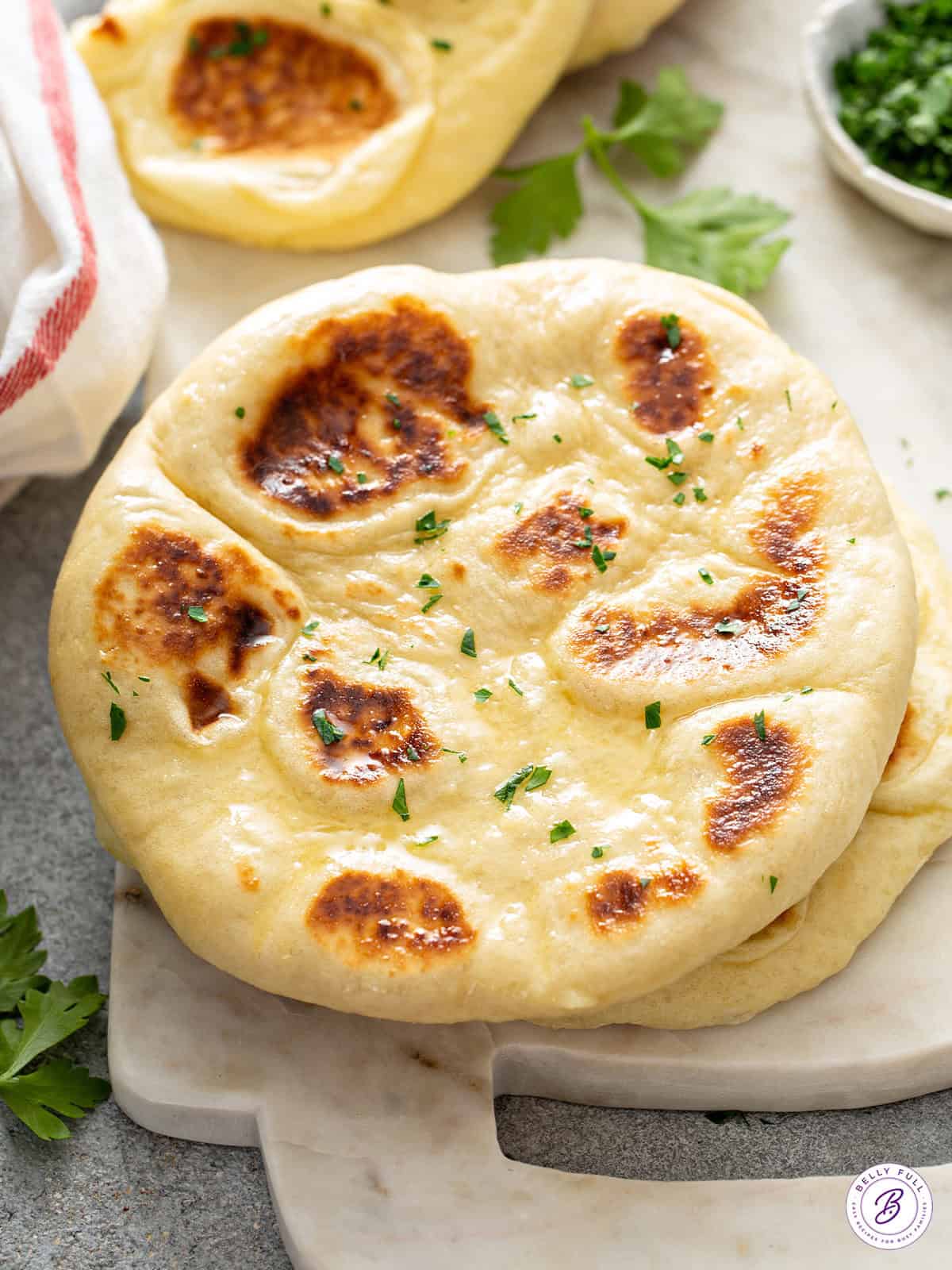 warm homemade naan with garlic, butter, and parsley