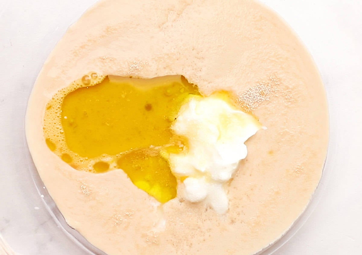 yeast, egg, oil, and yogurt in glass bowl