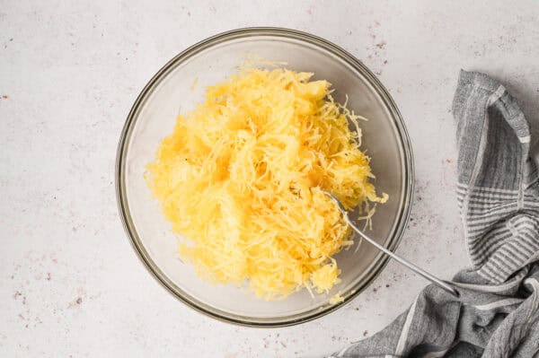 roasted spaghetti squash strands in bowl with fork