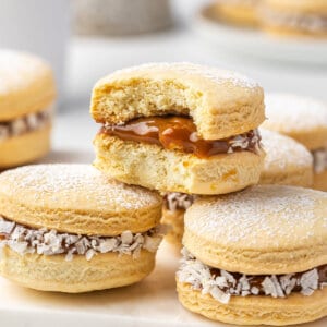 Three alfajores cookies, one with a bite missing.