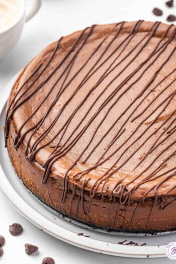 uncut chocolate mocha cheesecake with chocolate drizzle