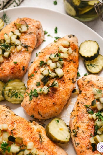 Dill pickel chicken on a white platter