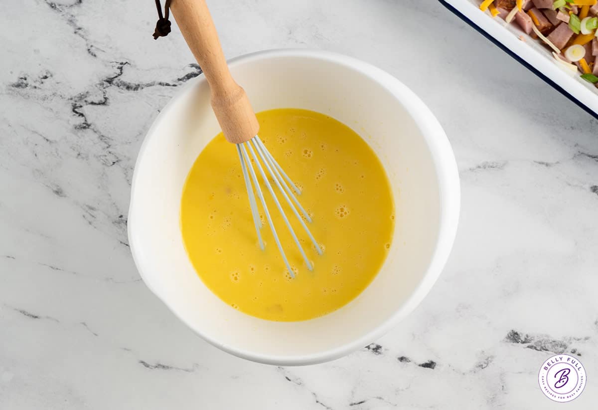egg custard with whisk in mixing bowl