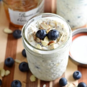 overnight breakfast oats in glass jar with blueberries and sliced almonds