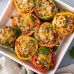 overhead baked stuffed peppers with melted cheese in casserole dish