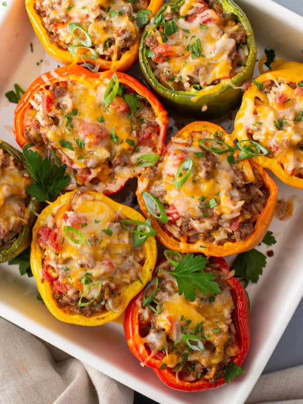 overhead baked stuffed peppers with melted cheese in casserole dish
