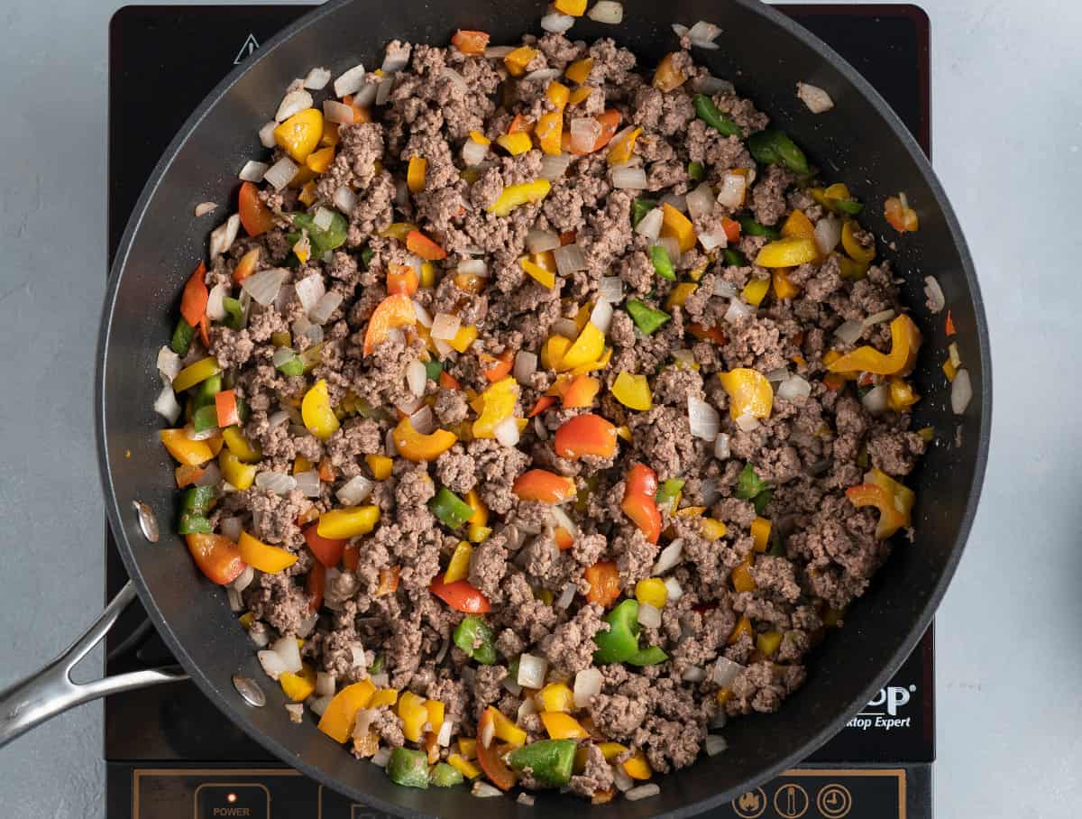 stuffed peppers filling cooking in skillet