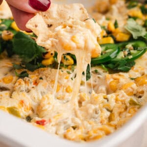 corn chip scooping hot cheesy corn dip