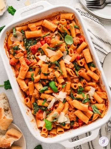 Overhead view of a baking dish of baked tomato sauce rigatoni