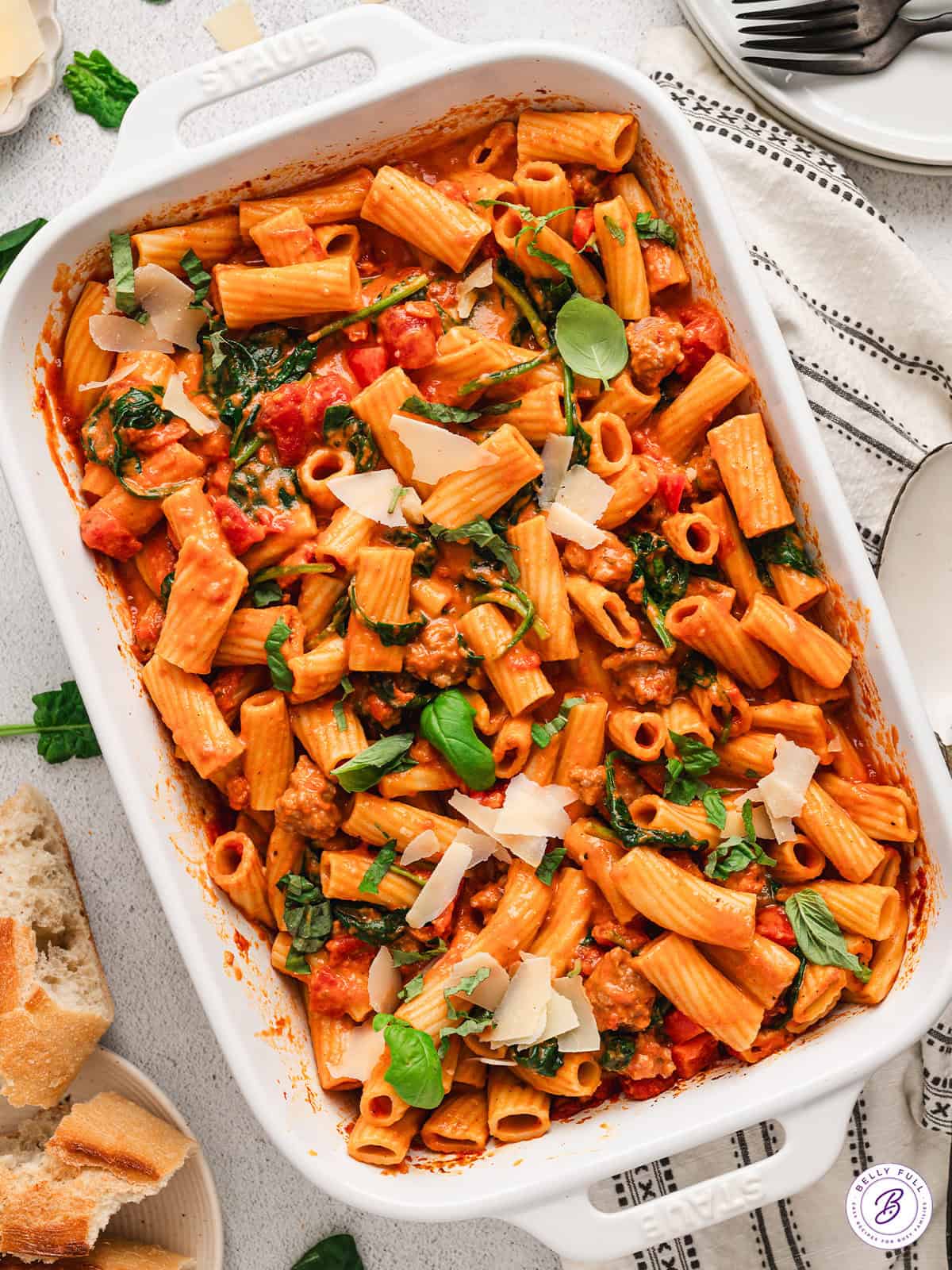 This Baked Tomato Sausage Rigatoni may be one of the easiest pasta dinners of all-time, with minimal prep and incredible flavor. Overhead view of a baking dish of baked tomato sauce rigatoni