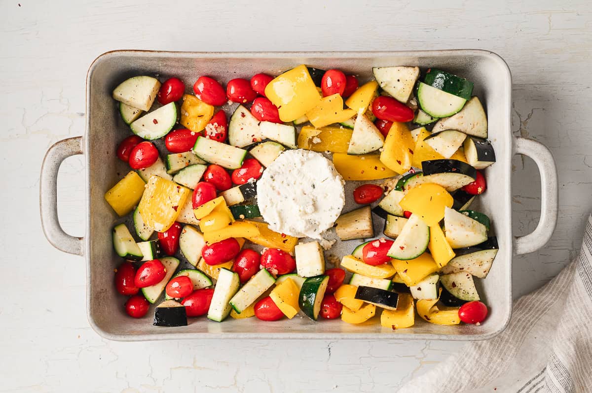 Veggies on a baking sheet with a circle of Boursin cheese