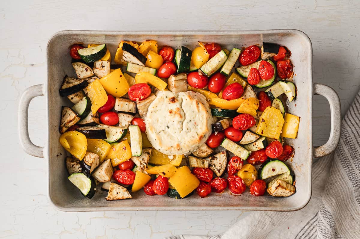 Baked veggies and Boursin cheese on a baking sheet