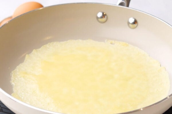 crepe cooking in fry pan