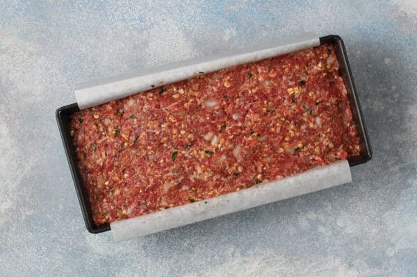 overhead unbaked meatloaf in loaf pan