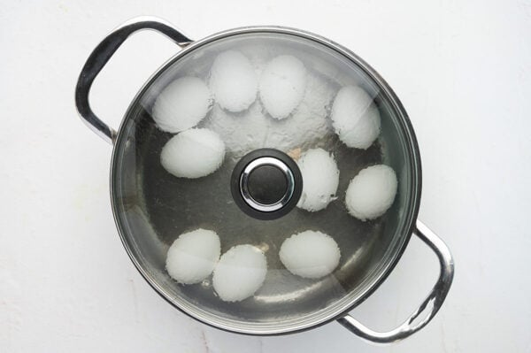 whole eggs in pot of boiling water