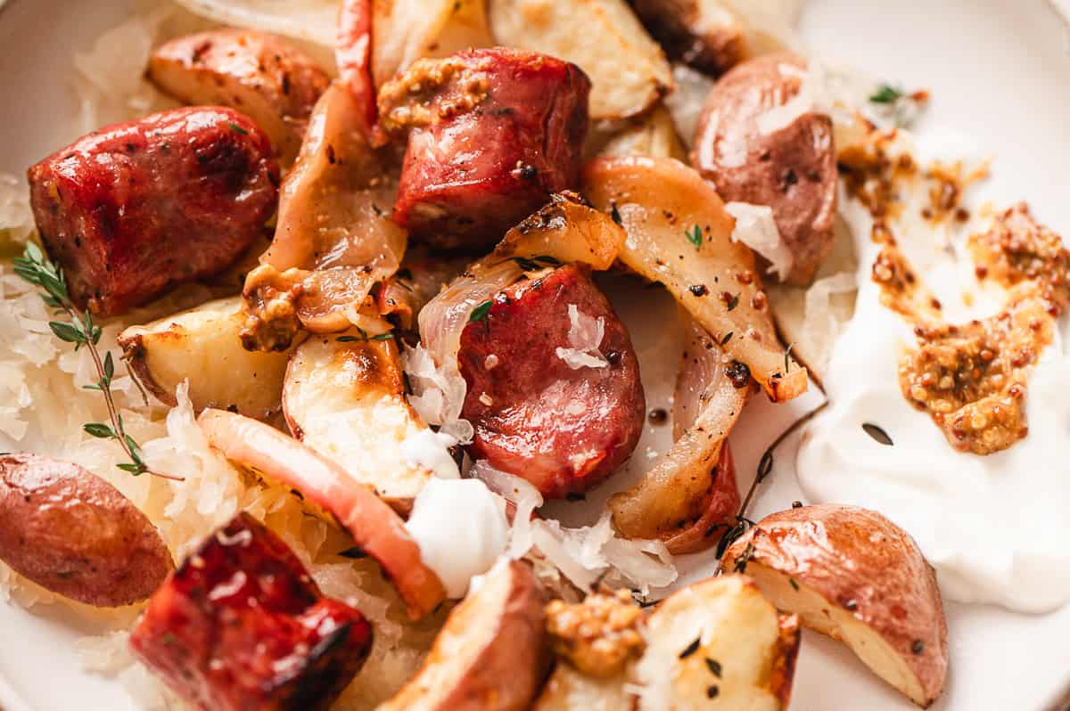 Close up of a plate of sheet pan potato, apple, and sausage