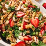 Overhead view of a platter of strawberry balsamic pasta salad