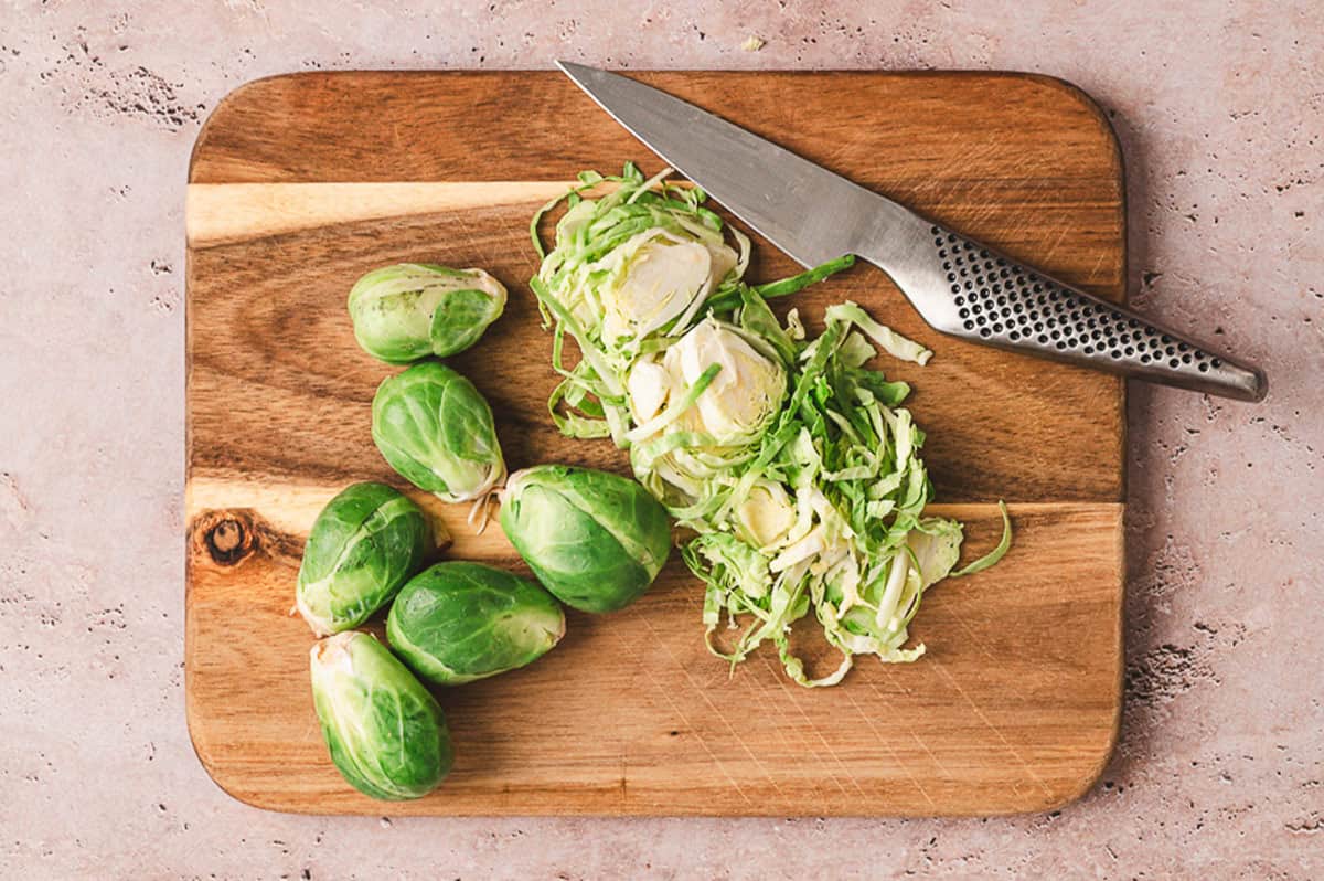 Shaved brussels sprouts on a cutting board