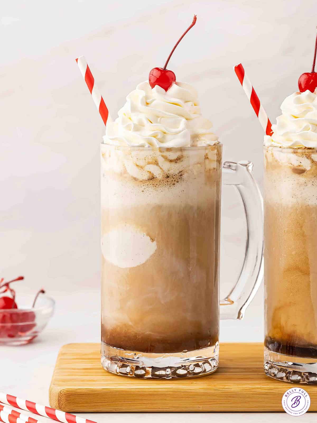 A boozy root beer float topped with whipped cream and a cherry